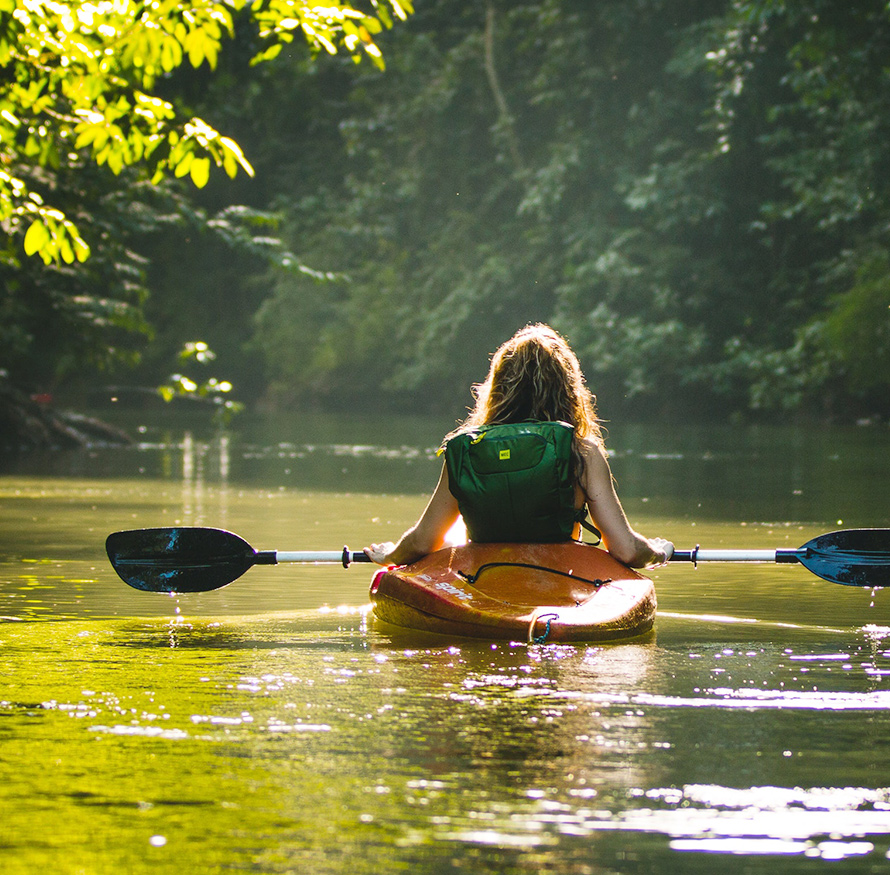 Woman in a kayak on a beautiful river in New York
