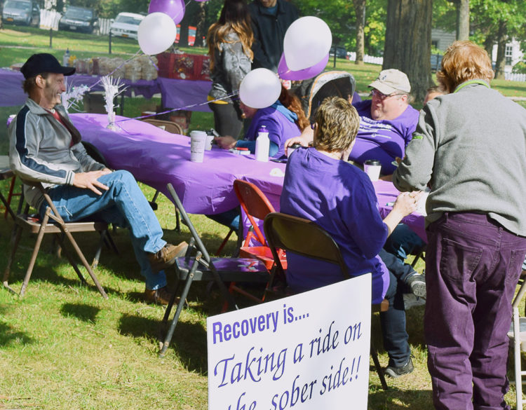 A group of people celebrating addiction recovery and sobriety