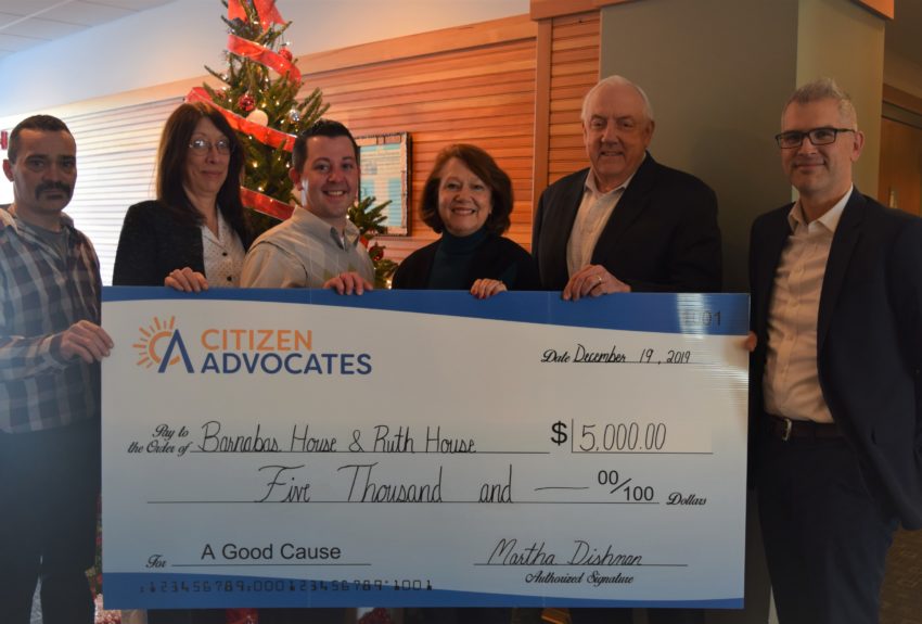 Citizen Advocates employees presenting donation check to employees of Ruth House and Barnabas House