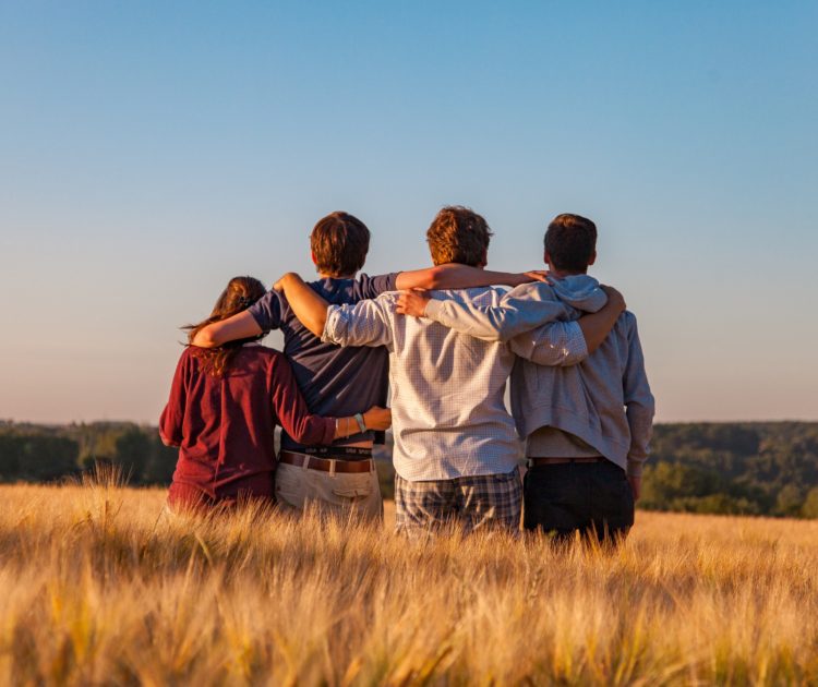 Group of friends embracing and supporting each other