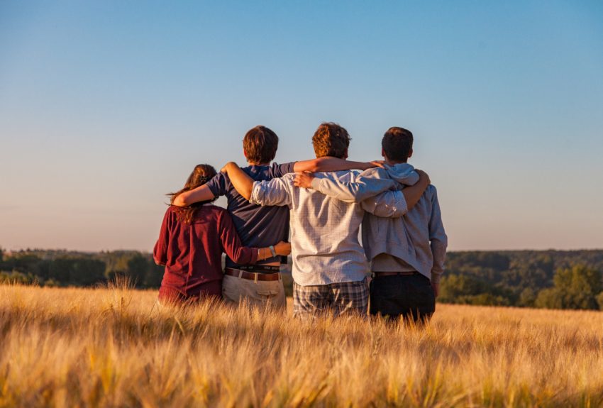 Group of friends embracing and supporting each other