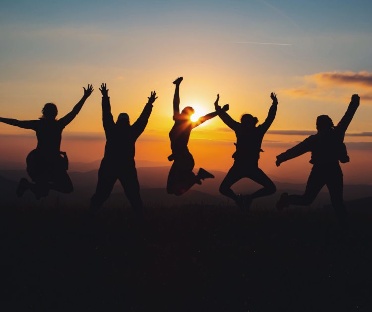 Silhouette of group jumping for joy