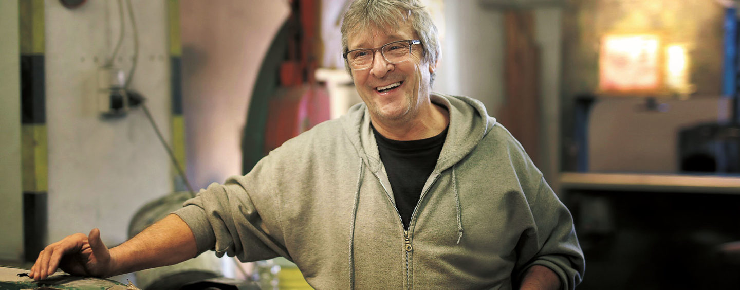 portrait of man smiling in a workshop