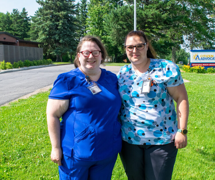 Two nurses stand outside an urgent care clinic where they perform lifesaving work.