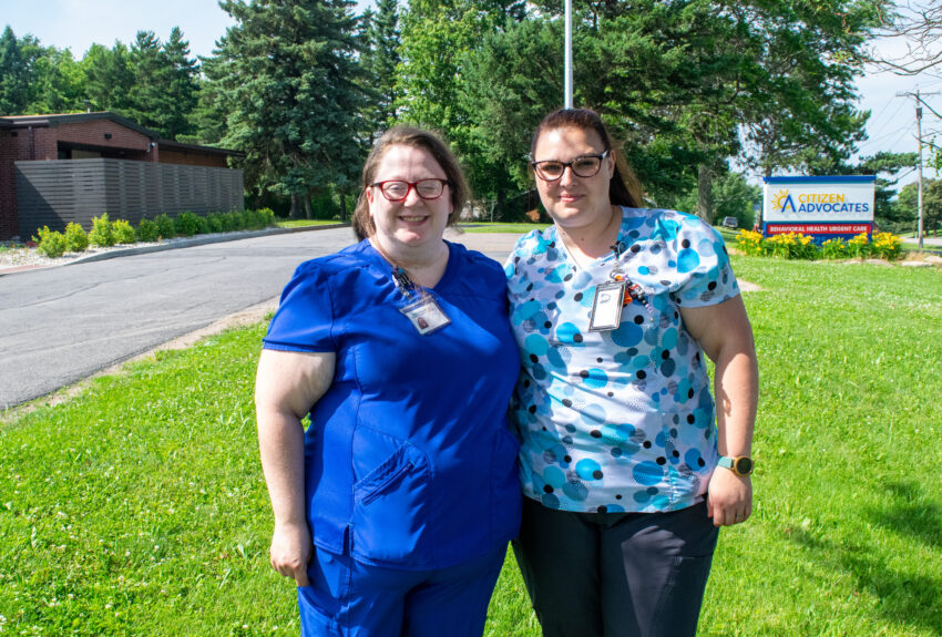Two nurses stand outside an urgent care clinic where they perform lifesaving work.
