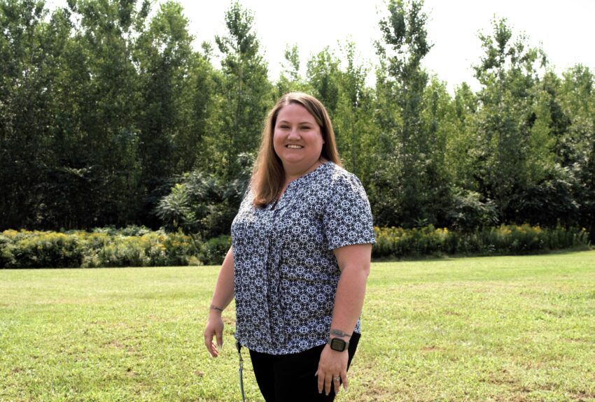 Susan Moore, Customer Support Team Lead at Citizen Advocates' Massena Outpatient Behavioral Health Clinic, stands outside on a sunny day. Her role exemplifies the impact of a Customer Support job in behavioral health.