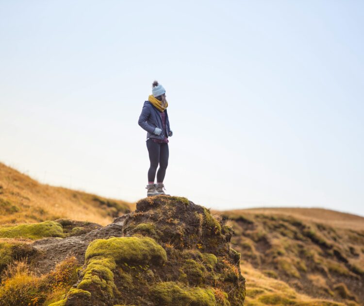 A hiker pauses to take in the view, representing a moment of clarity when thinking about when mental health is an emergency.