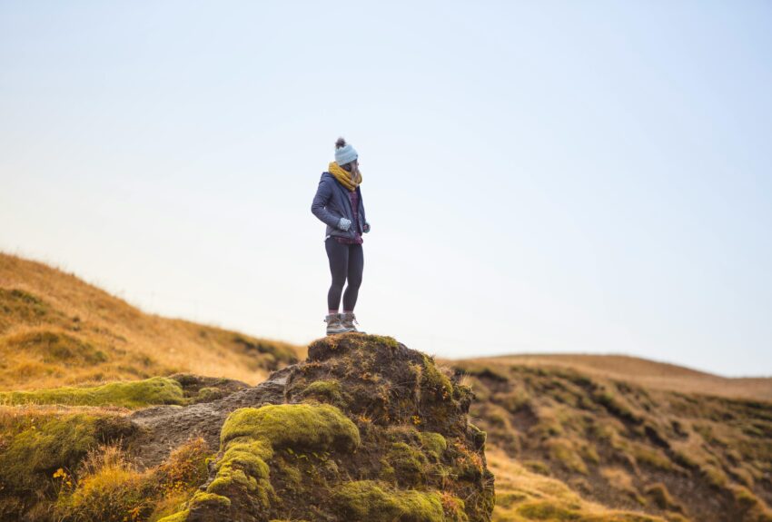 A hiker pauses to take in the view, representing a moment of clarity when thinking about when mental health is an emergency.