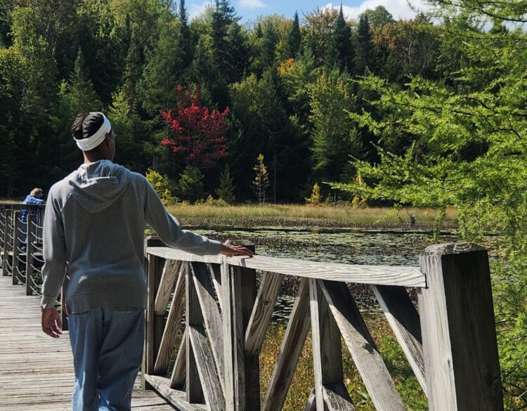 A community club member enjoys a nature walk.