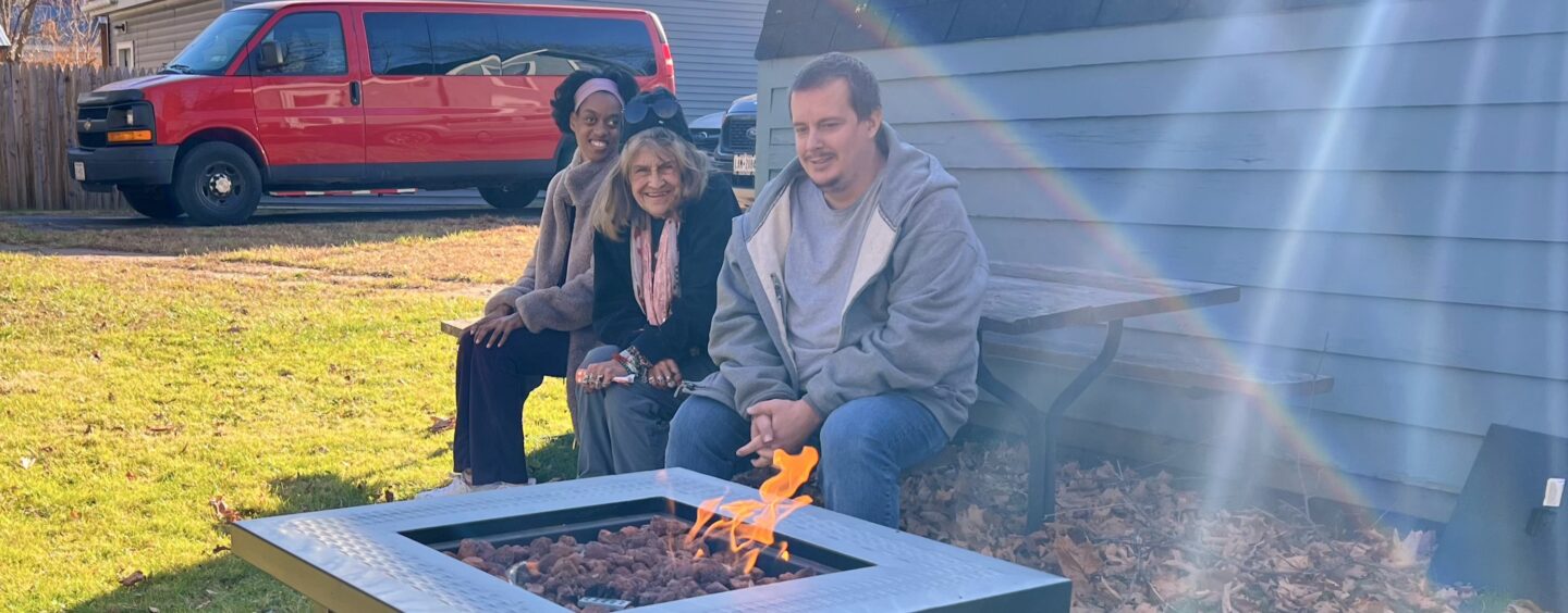 Community club members enjoy a brisk fall day by the outdoor fireplace.