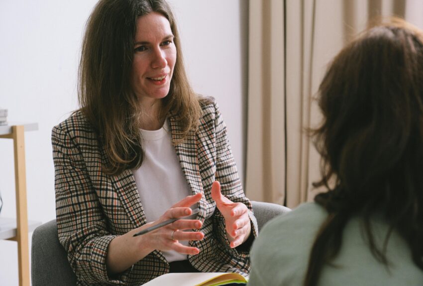 A therapist conducts a talk therapy session with a patient.