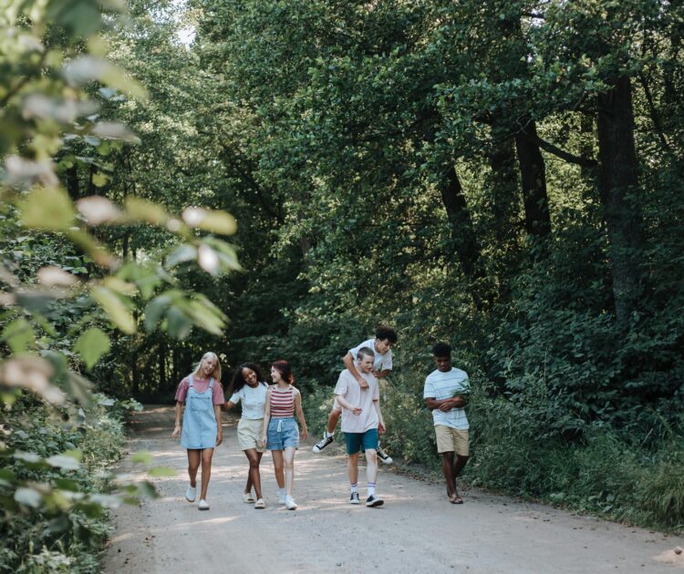 Teenagers walk in nature, symbolizing the importance of early intervention for youth mental health.