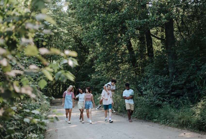 Teenagers walk in nature, symbolizing the importance of early intervention for youth mental health.