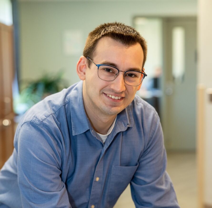 An IT employee smiles because he loves his career at Citizen Advocates.