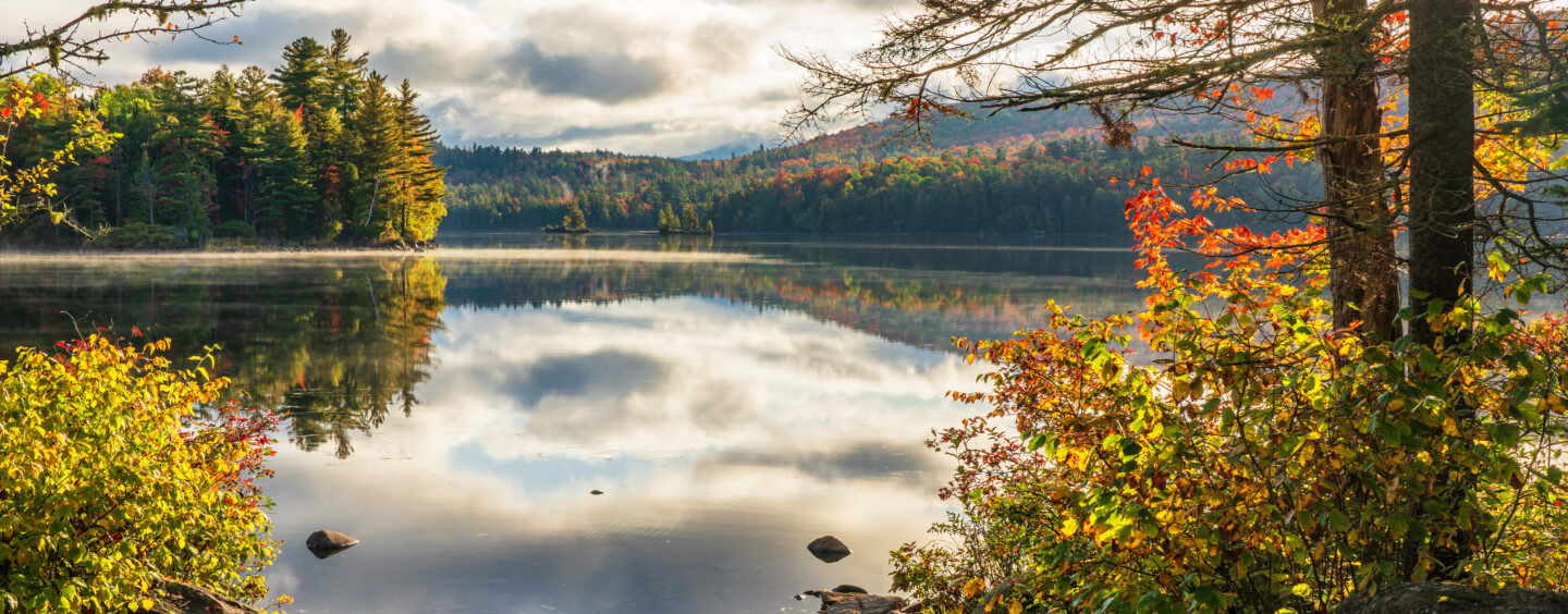 Autumn view near Saranac Lake, the light on the water reflecting the hope offered by mental health and addiction services at Citizen Advocates.