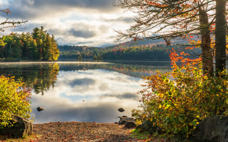 Autumn view near Saranac Lake, the light on the water reflecting the hope offered by mental health and addiction services at Citizen Advocates.