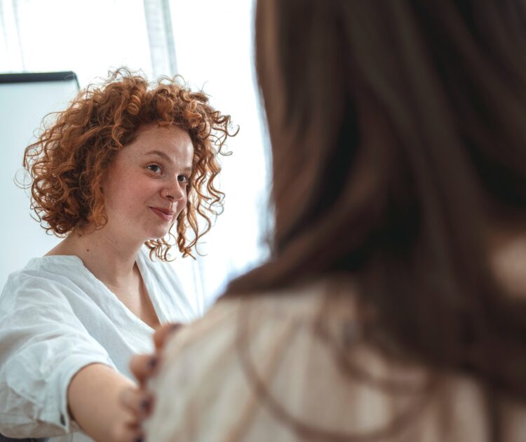 An addiction counselor consoles a patient.