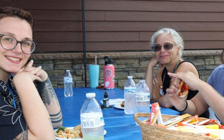 Three Citizen Advocates employees enjoy a picnic lunch.