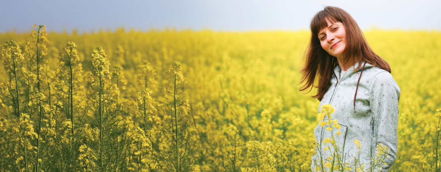 A woman in a field thinks about Behavioral Health Campuses and how they are always open.