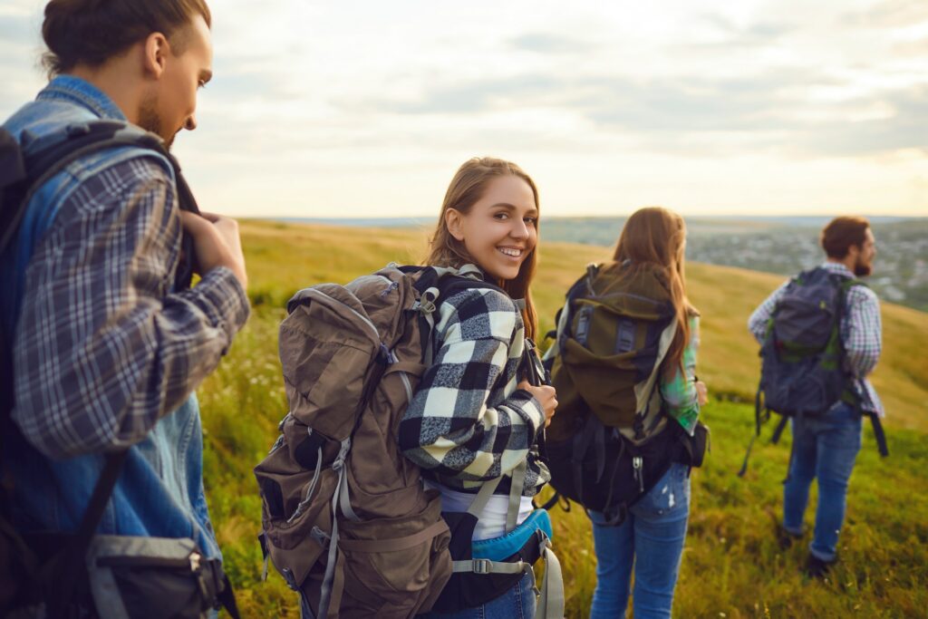 A group of friends go on a hike. A woman turns back, thinking about the benefits of Cognitive Processing Therapy.
