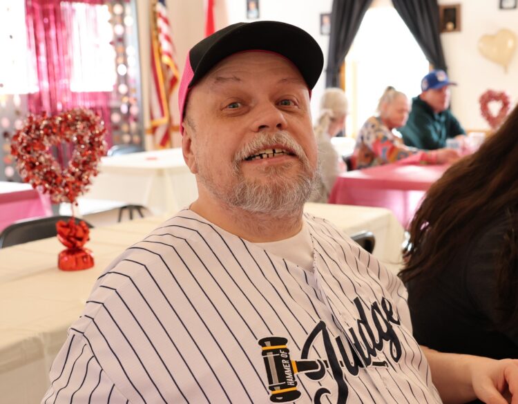 An OPWDD Supervised and Supportive Housing participant enjoys a Valentine's Party.