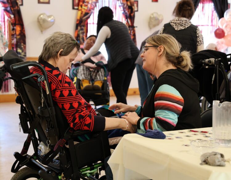 An OPWDD Supervised and Supportive Housing participant enjoys a Valentine's Party.