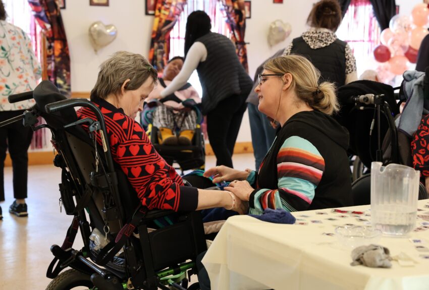 An OPWDD Supervised and Supportive Housing participant enjoys a Valentine's Party.