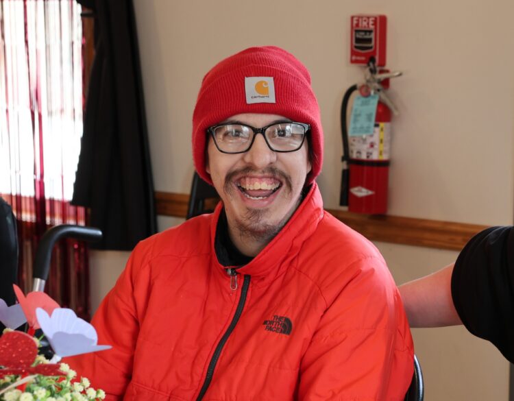 An OPWDD Supervised and Supportive Housing participant enjoys a Valentine's Party.