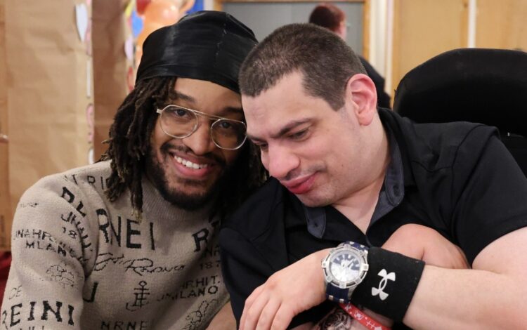 A direct support professional (or DSP) smiles with an individual they support.