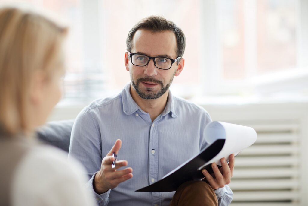 A psychiatric nurse practitioner speaks with a patient.