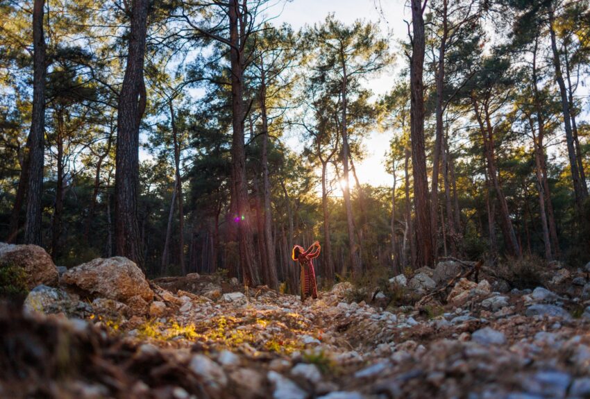 A woman engages in dancing outside, which is Expressive Arts Therapy.
