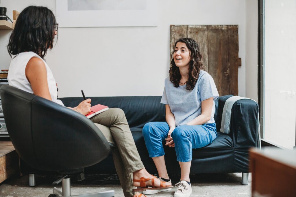 Psychotherapy session, woman talking to her therapist on a couch.
