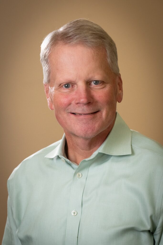 A professional headshot of Mark Hasselwander.