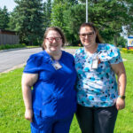 Two nurses stand outside an urgent care clinic where they perform lifesaving work.